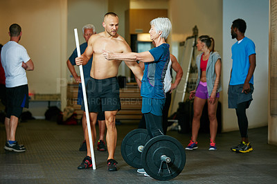 Buy stock photo Shot of a senior woman working out with her fitness instructor