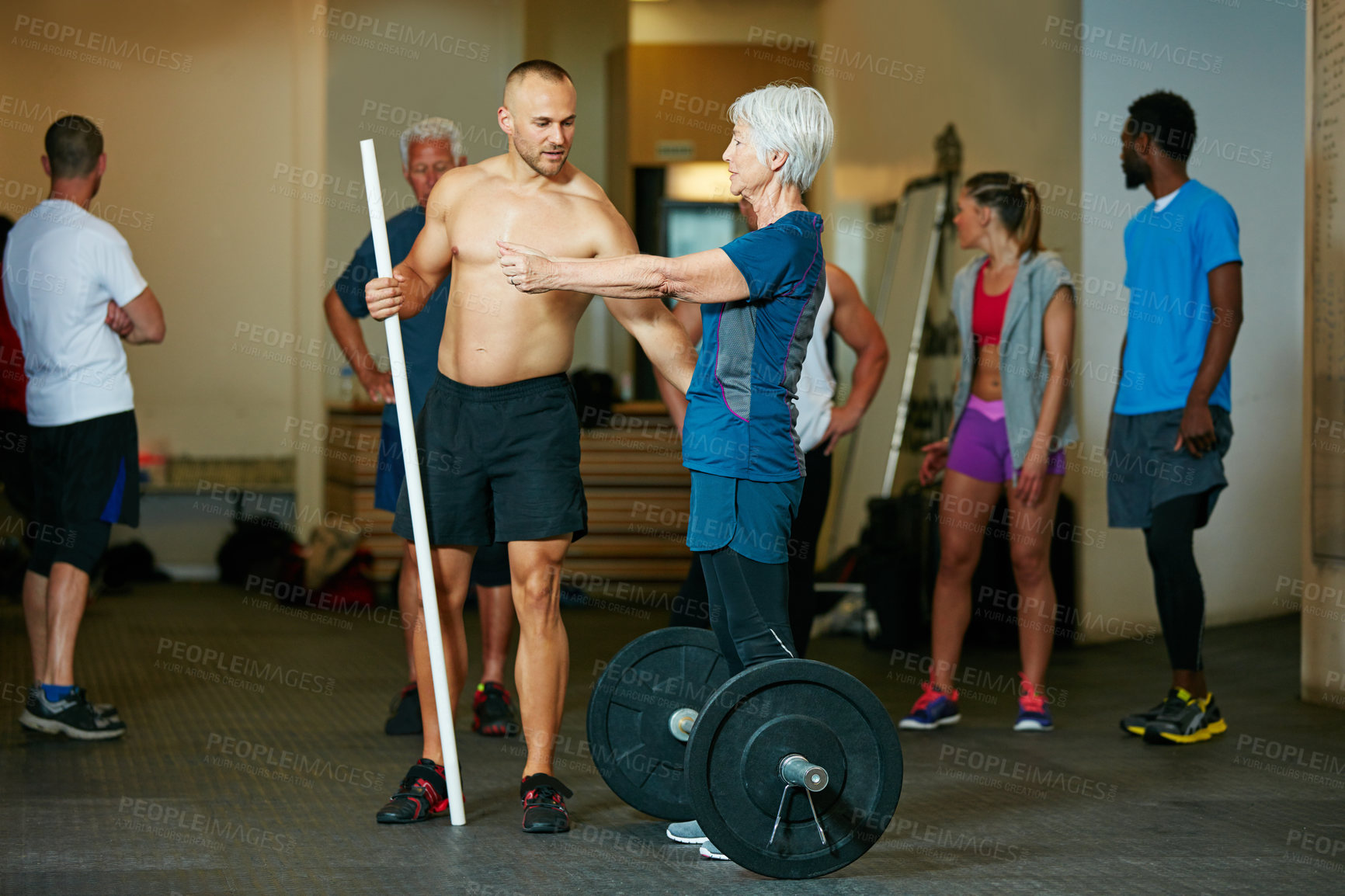 Buy stock photo Shot of a senior woman working out with her fitness instructor