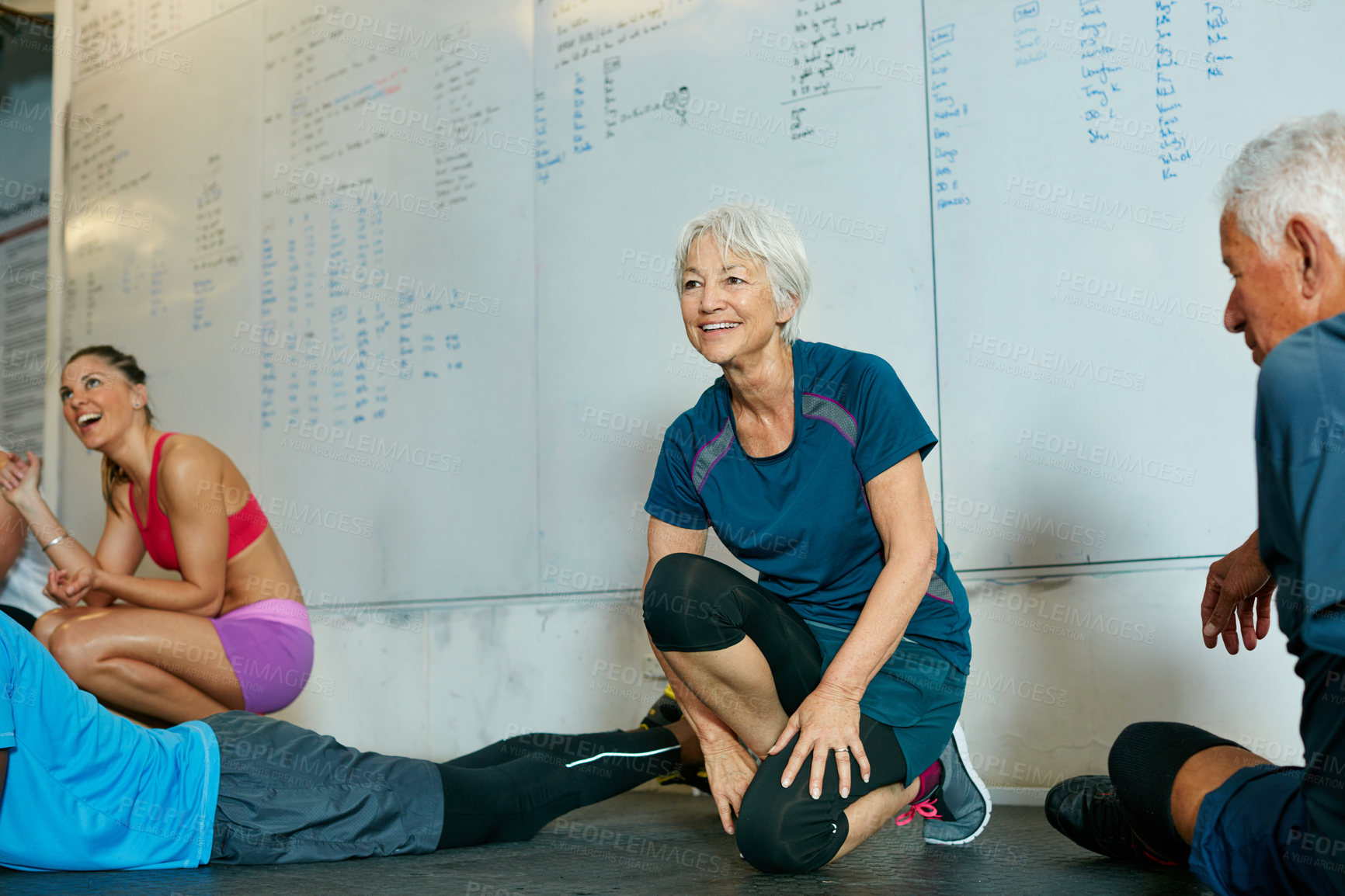 Buy stock photo Shot of a group of people working out in the gym