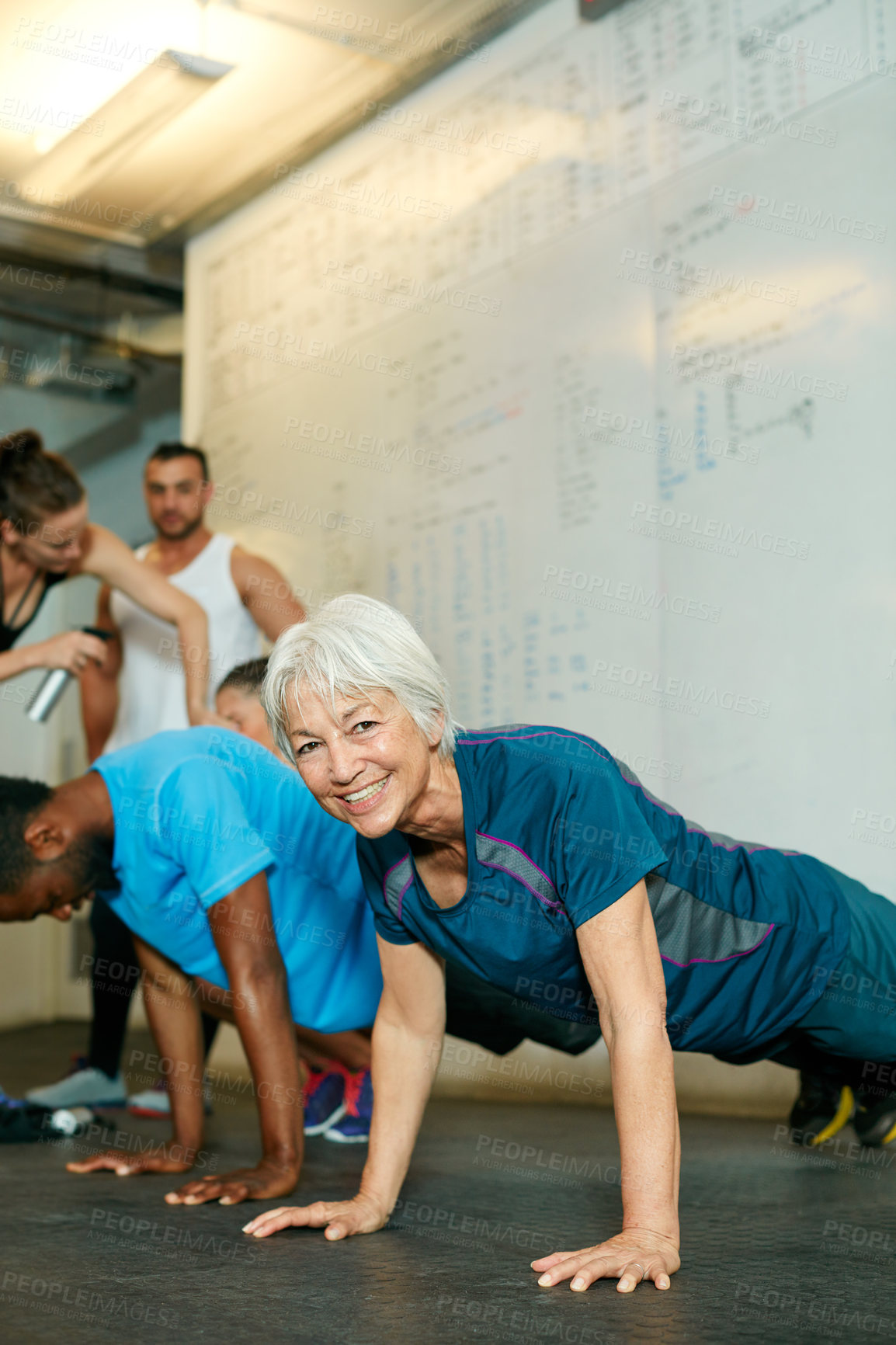 Buy stock photo Shot of a group of people working out in the gym