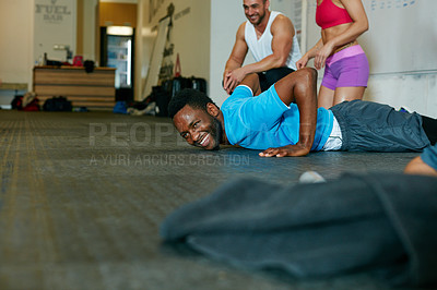 Buy stock photo Shot of a group of people working out in the gym