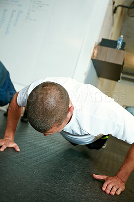 Buy stock photo Shot of a man working out in the gym