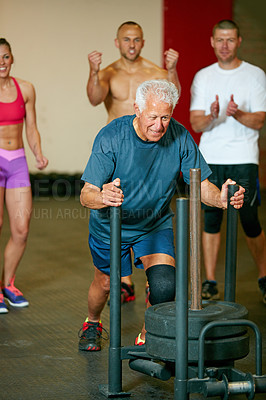 Buy stock photo Cropped shot of a group of people cheering on a senior man in the gym