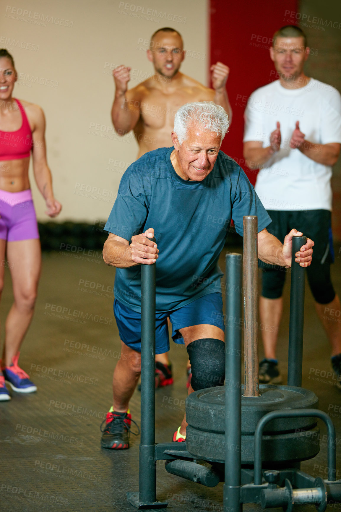 Buy stock photo Cropped shot of a group of people cheering on a senior man in the gym