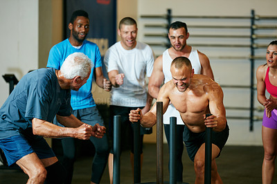 Buy stock photo Cropped shot of a group of people cheering on a young man in the gym