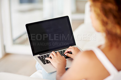 Buy stock photo Rearview shot of a woman using a laptop at home