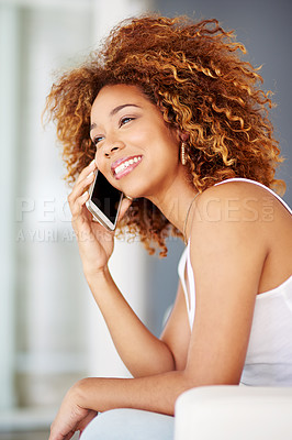 Buy stock photo Shot of a young woman using her phone on the sofa at home