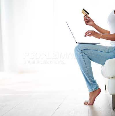 Buy stock photo Cropped shot of a woman using her credit card to make an online payment at home