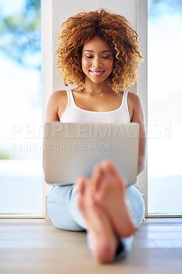 Buy stock photo Shot of a young woman using a laptop on the floor at home