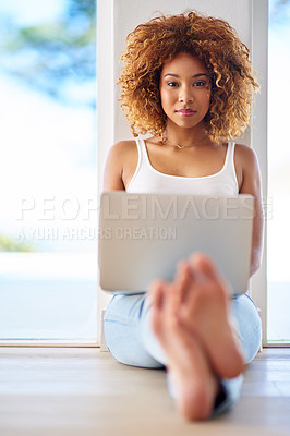 Buy stock photo Portrait of a young woman using a laptop on the floor at home
