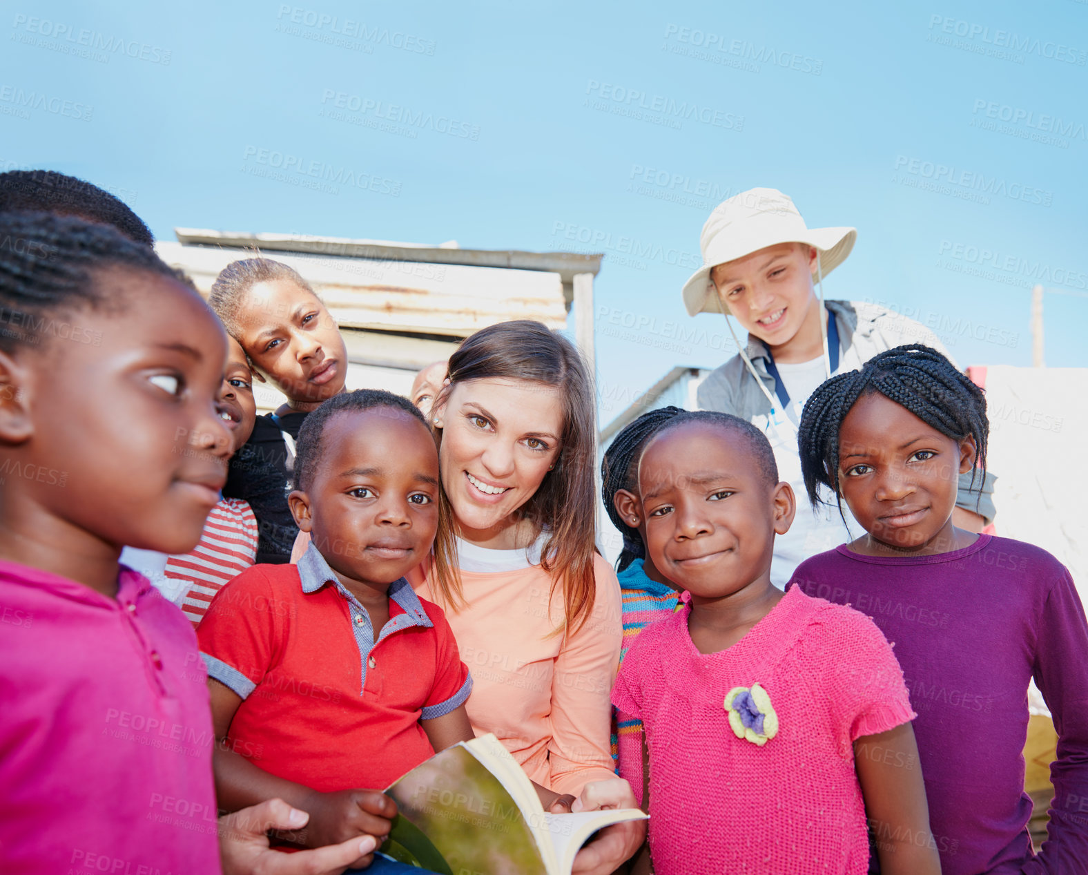 Buy stock photo Reading, welfare and portrait of children outdoor for ngo organization, education drive and support. Learning foundation, social responsibility and humanitarian with woman and kids for volunteer