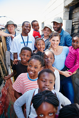 Buy stock photo Cropped corporate of volunteer workers and a group of children at a community outreach event