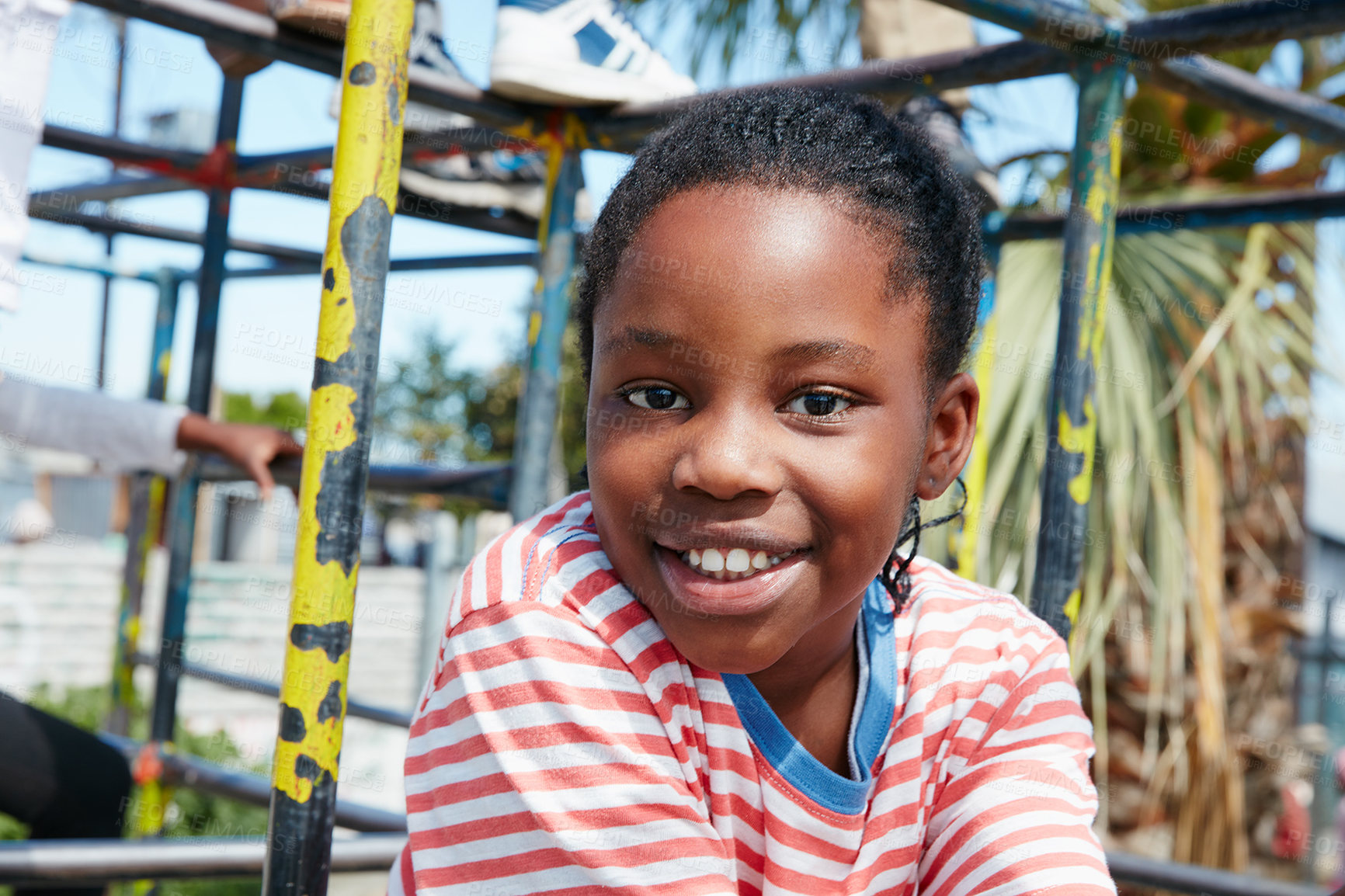 Buy stock photo Portrait of a happy little girl playing on a jungle gym