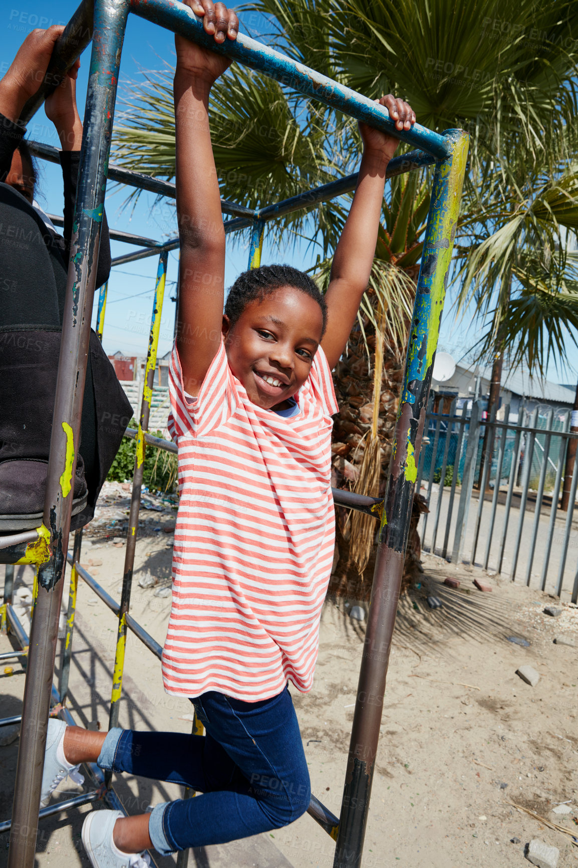 Buy stock photo Portrait of a happy little girl hanging on a jungle gym