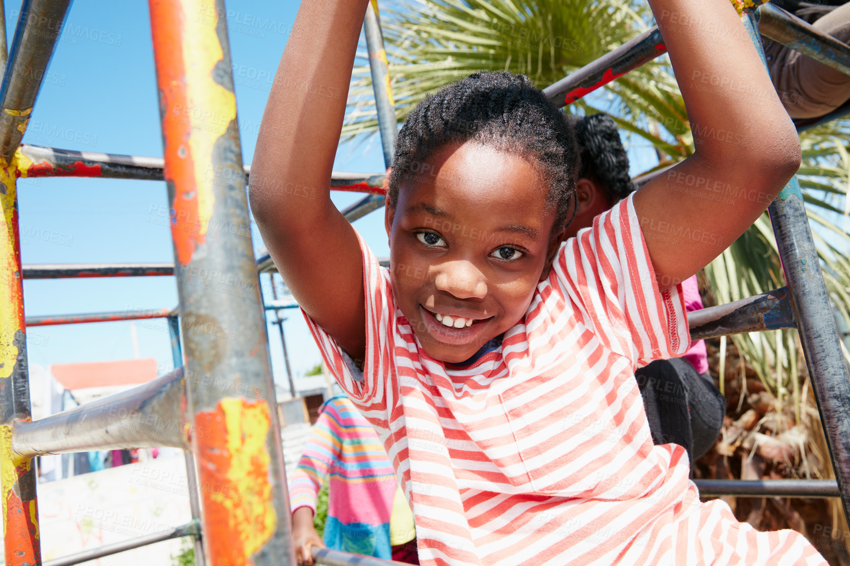 Buy stock photo Portrait of a happy little girl hanging on a jungle gym