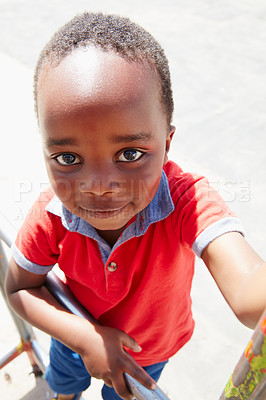 Buy stock photo Portrait of a happy little boy playing on a jungle gym