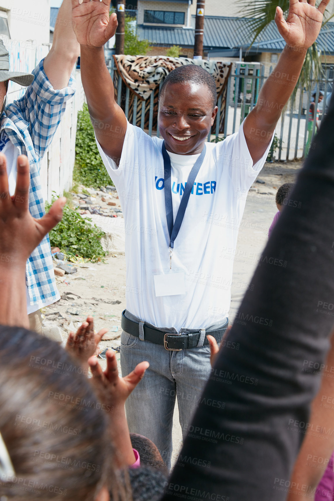 Buy stock photo Cropped shot of volunteer workers addressing a group of children at a community outreach event