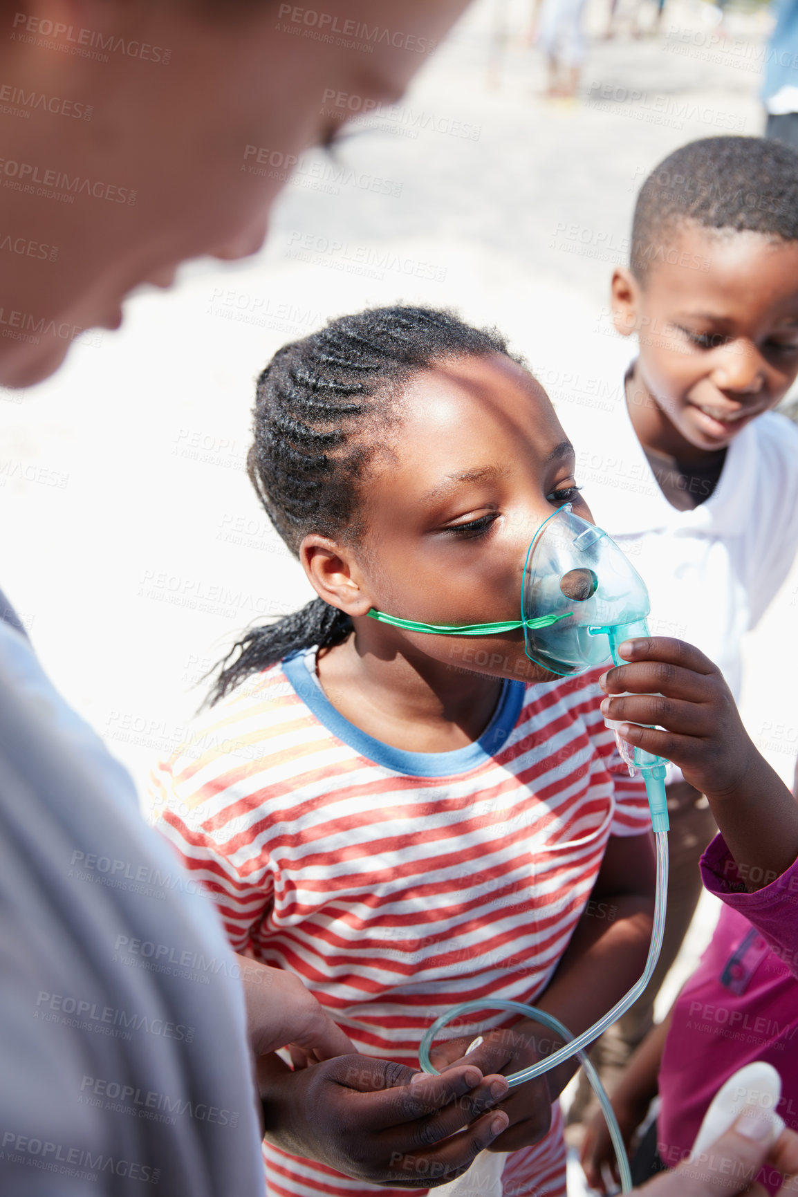 Buy stock photo Shot of a volunteer doctor giving checkups to underprivileged kids