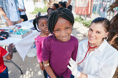 Buy stock photo Portrait of volunteer nurses giving checkups to underprivileged kids