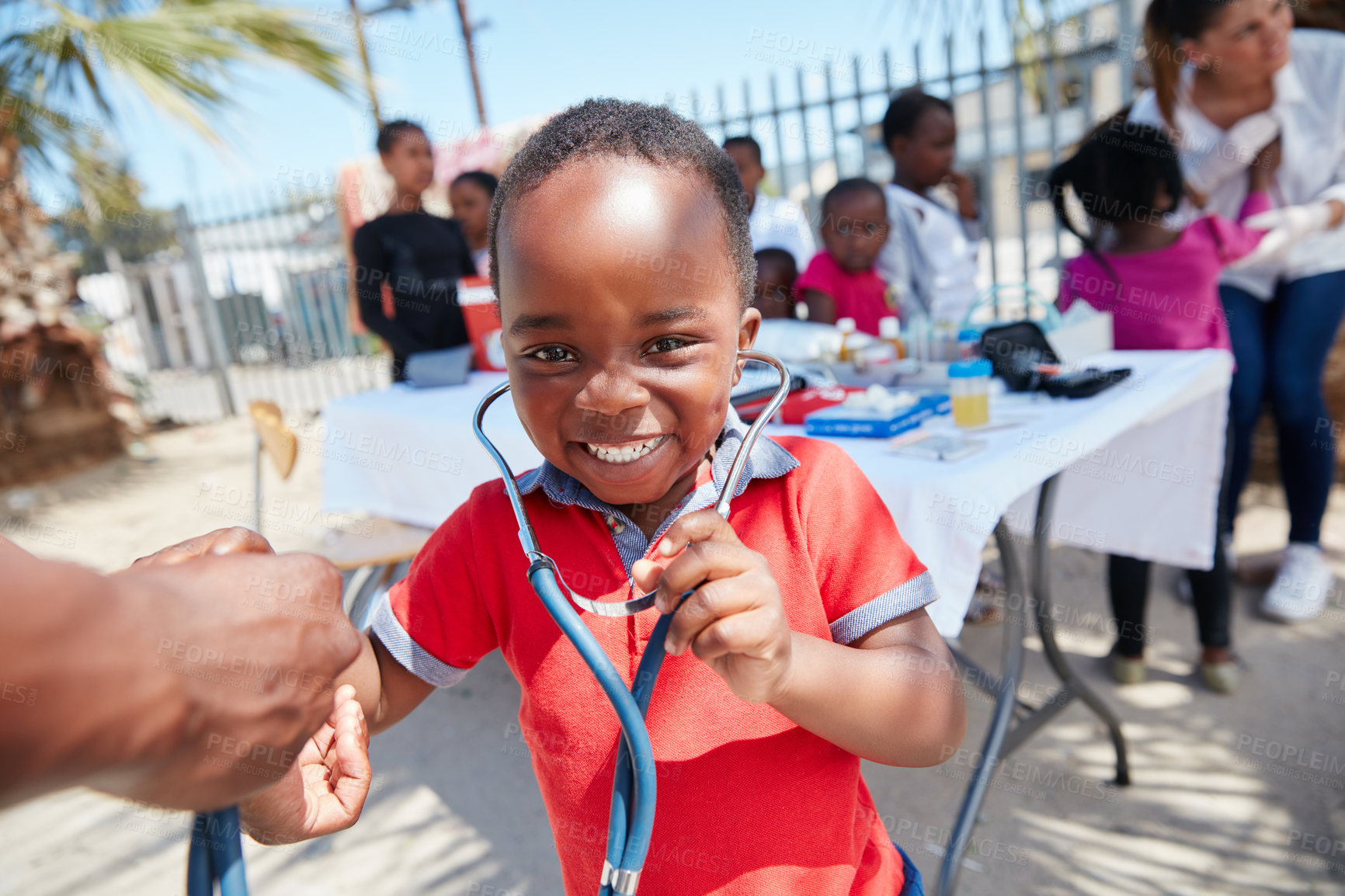 Buy stock photo Cropped shot of volunteer nurses giving checkups to underprivileged kids