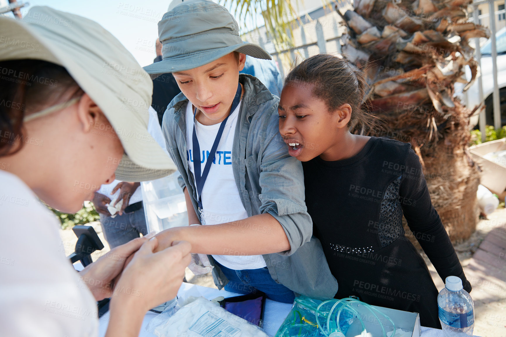 Buy stock photo Cropped shot of volunteer nurses giving checkups to underprivileged kids