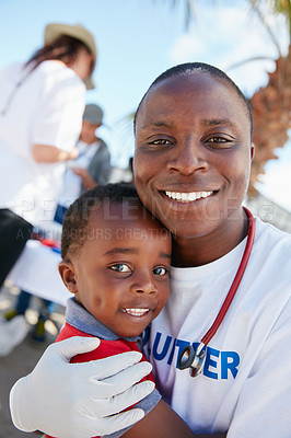 Buy stock photo Portrait of a caring volunteer doctor giving checkups to underprivileged kids