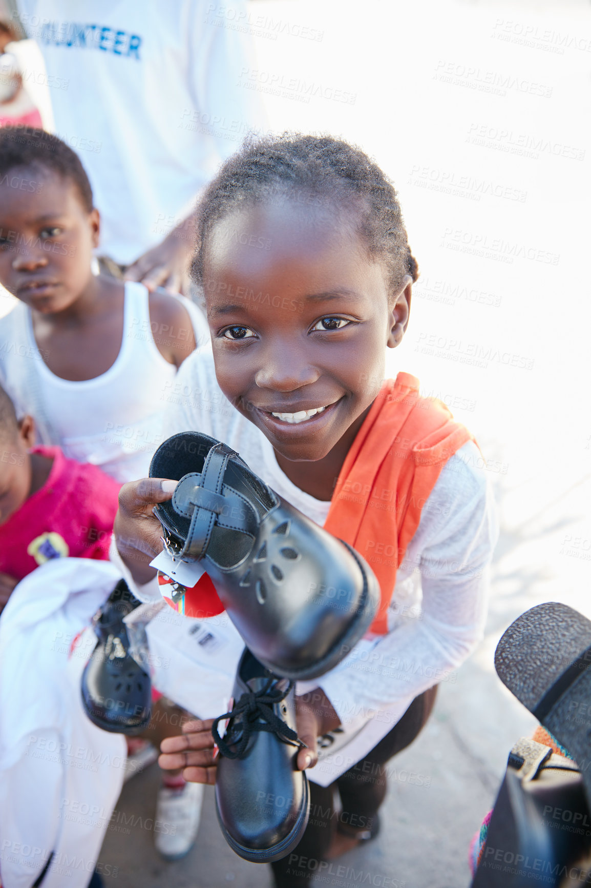 Buy stock photo Cropped shot of underprivileged kids receiving clothing