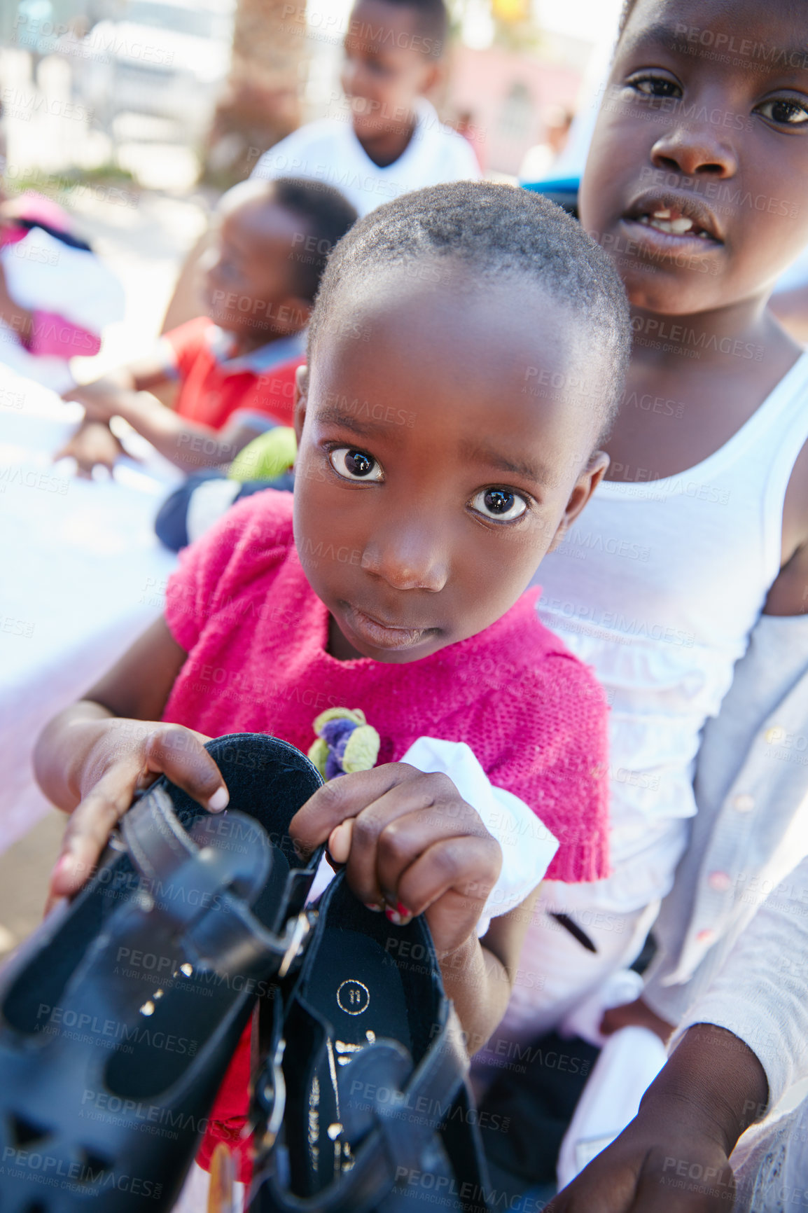 Buy stock photo Cropped shot of underprivileged kids receiving clothing