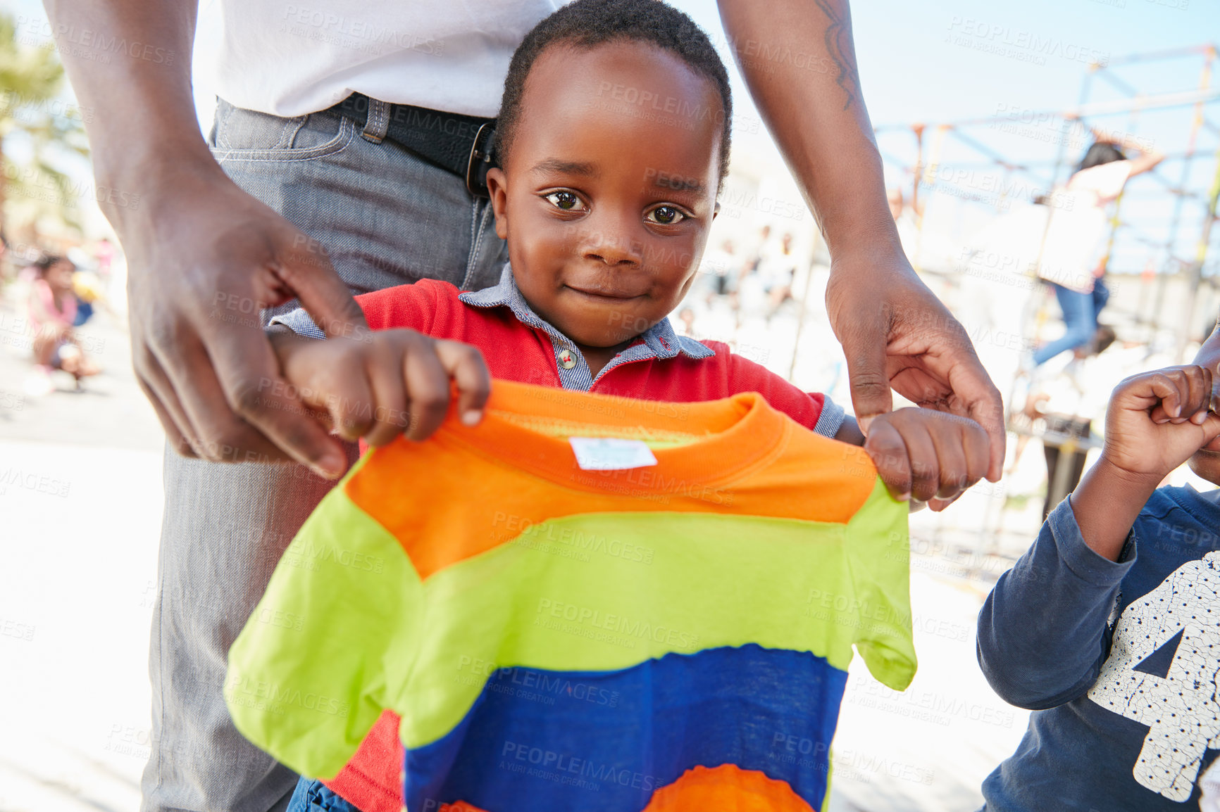 Buy stock photo Cropped shot of underprivileged kids receiving clothing