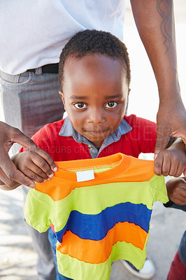 Buy stock photo Cropped shot of underprivileged kids receiving clothing