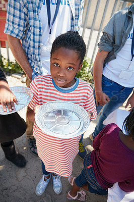 Buy stock photo Cropped portrait of a young girl getting fed at a food outreach