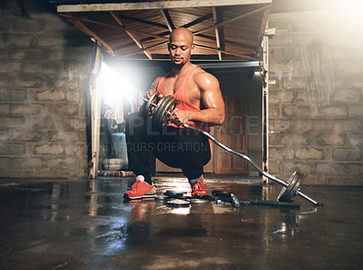 Buy stock photo Full length shot of a muscular young man adding weights to his bar