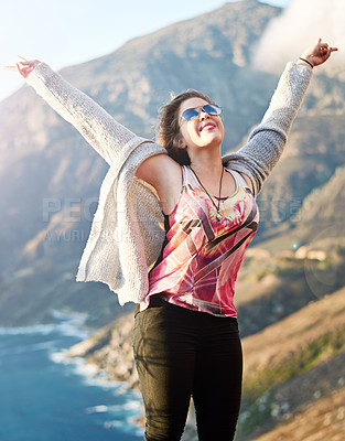 Buy stock photo Cropped shot of a teenage girl standing with her arms raised outdoors