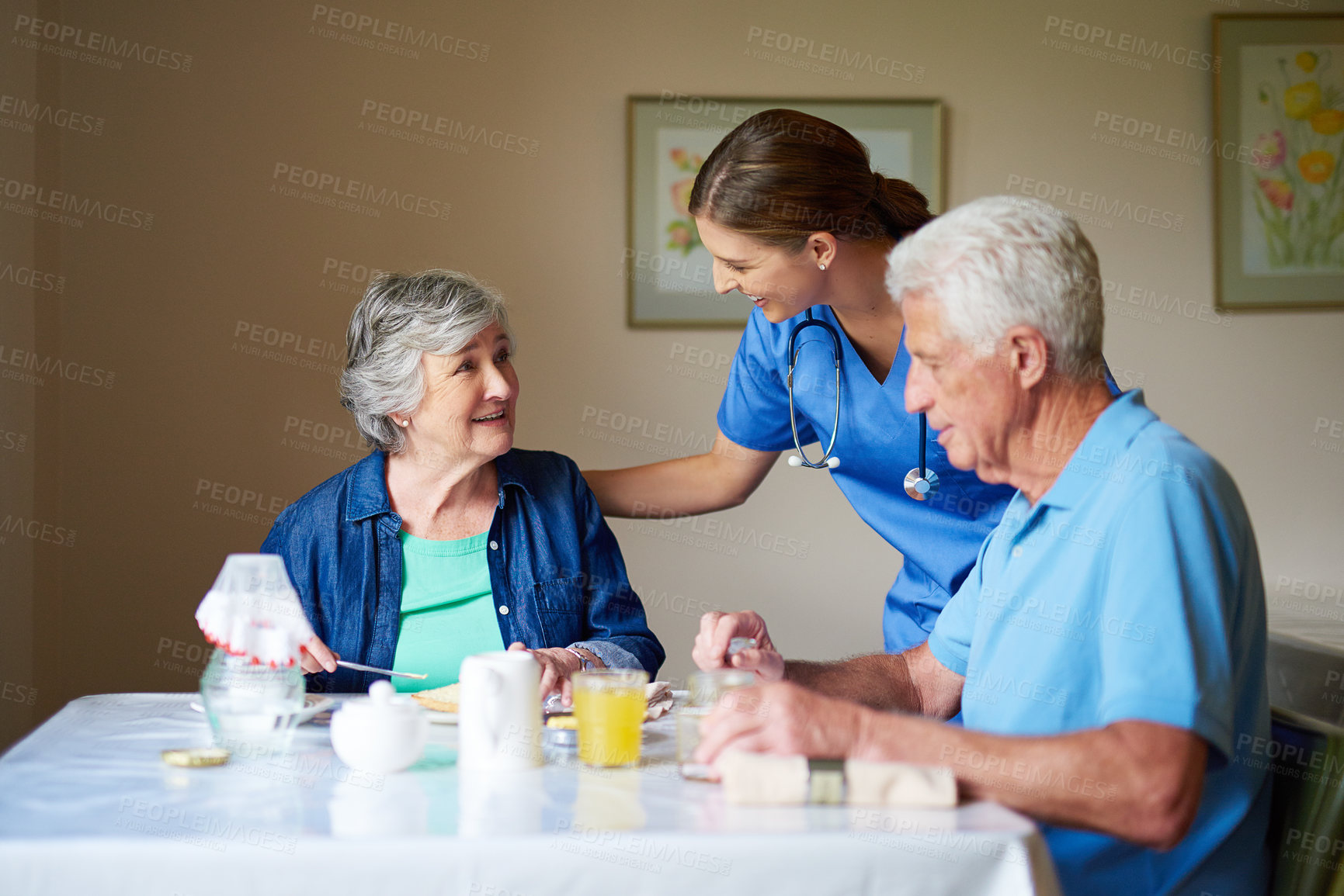 Buy stock photo Shot of two residents and a nurse at a retirement home