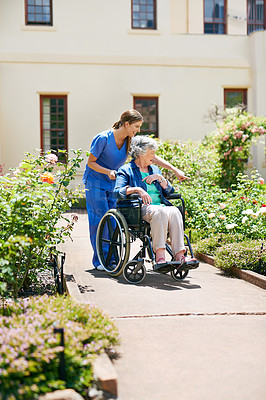 Buy stock photo Shot of a resident and a nurse outside in the retirement home garden