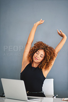 Buy stock photo Shot of a young businesswoman feeling relaxed at her desk