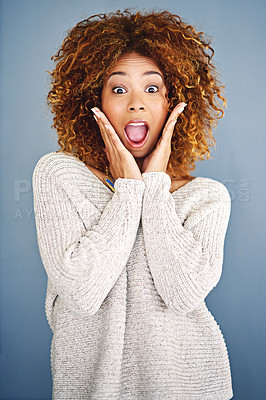 Buy stock photo Studio shot of a young woman looking surprised against a grey background