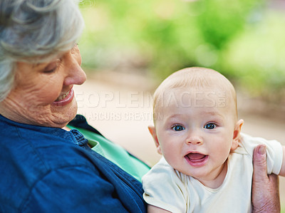 Buy stock photo Cropped shot of a baby boy spending time outdoors with his grandmother