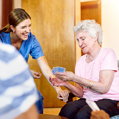 Buy stock photo Cropped shot of seniors playing cards in their retirement home