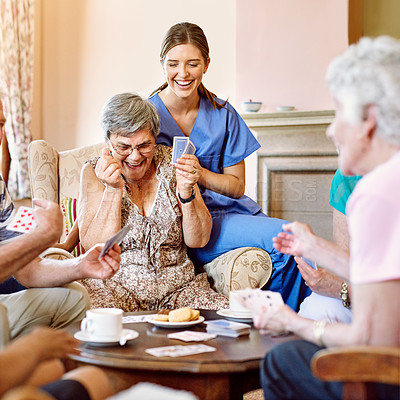 Buy stock photo Cropped shot of seniors playing cards in their retirement home