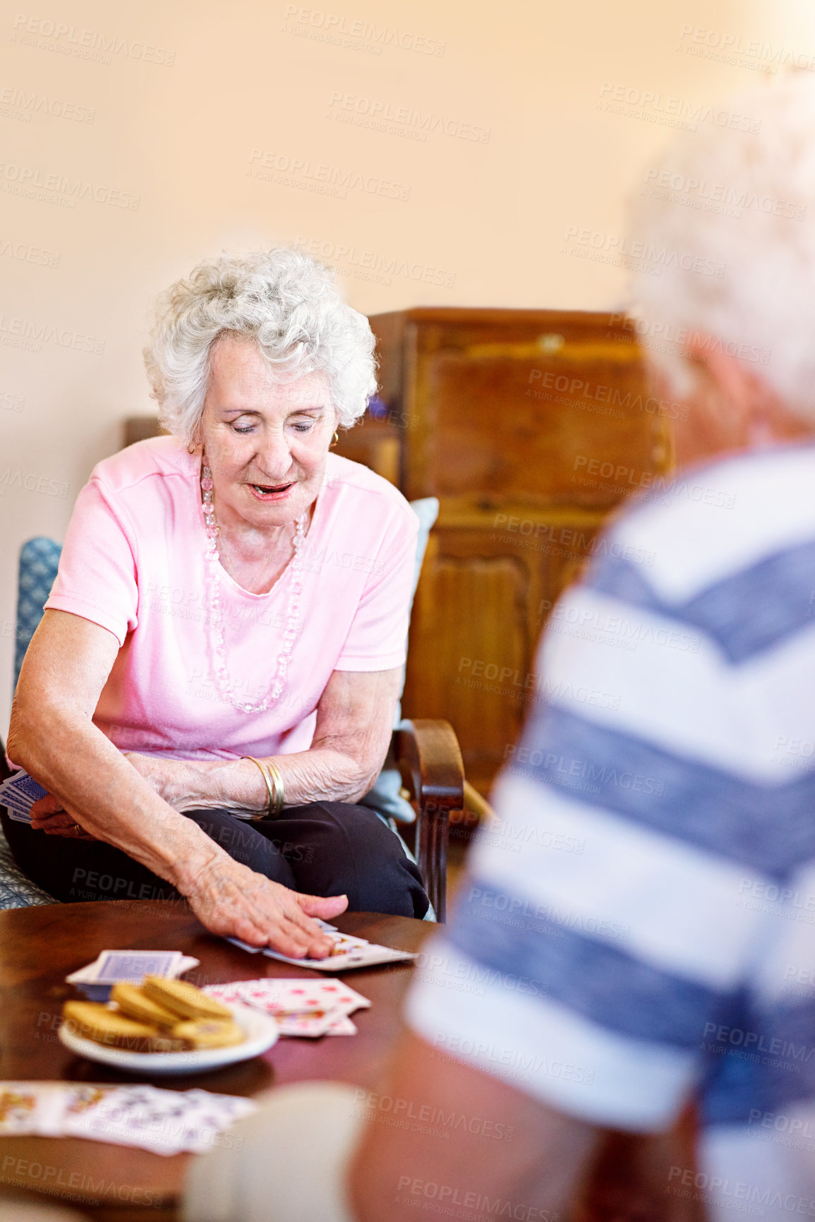 Buy stock photo Cropped shot of seniors playing cards in their retirement home