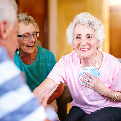 Buy stock photo Cropped shot of seniors playing cards in their retirement home