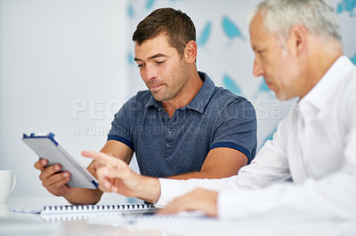 Buy stock photo Cropped shot of two men working in the office