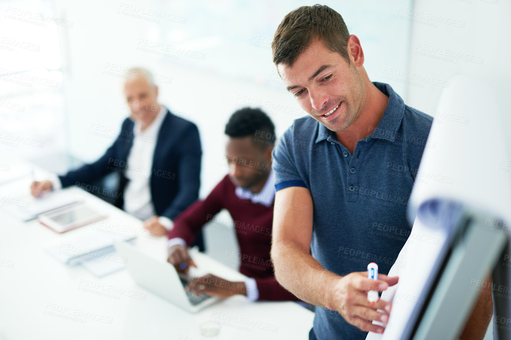 Buy stock photo Cropped shot of a young businessman giving a presentation in the boardroom