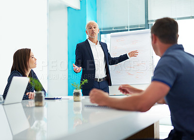 Buy stock photo Cropped shot of a mature businessman giving a presentation in the boardroom