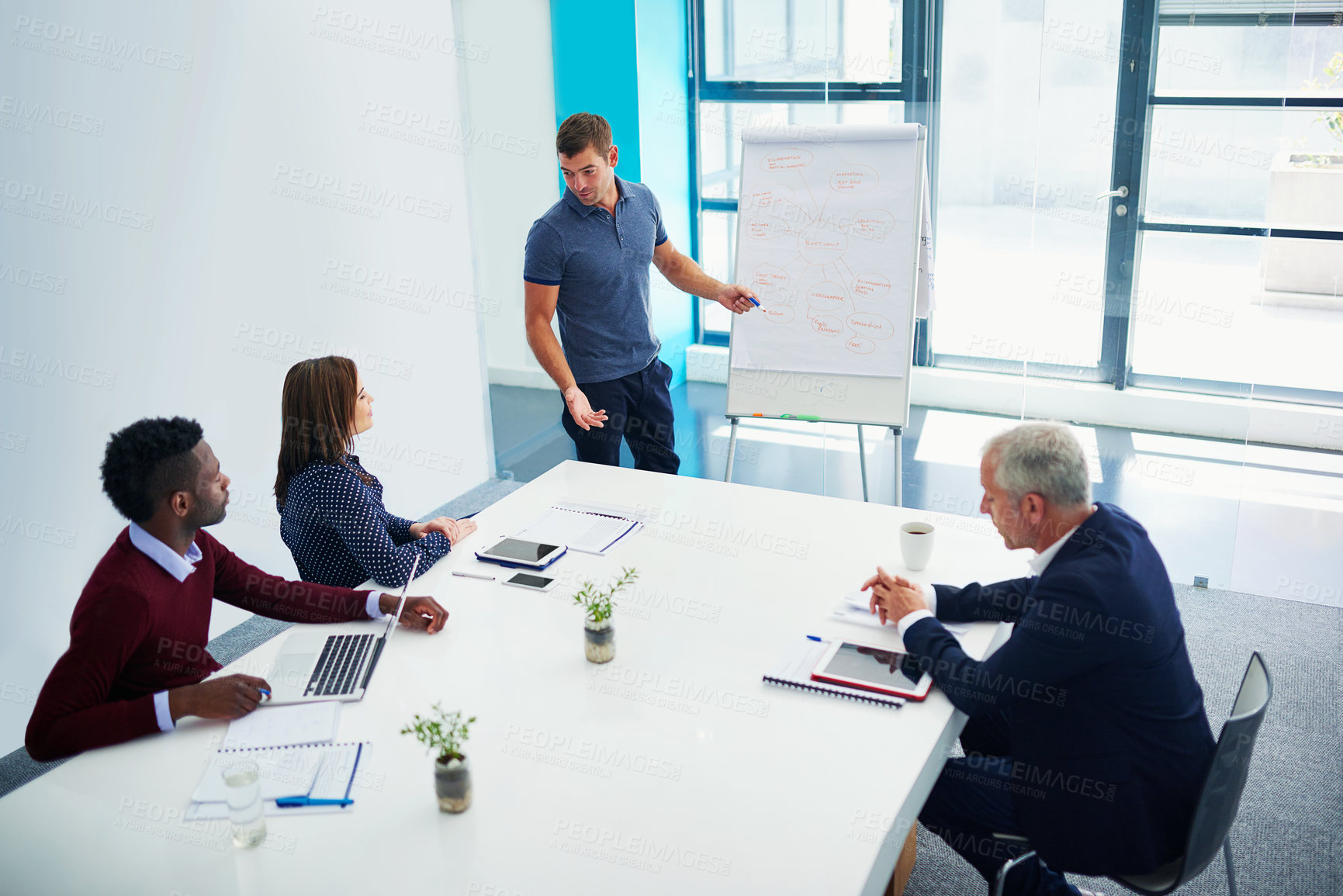 Buy stock photo Cropped shot of a young businessman giving a presentation in the boardroom