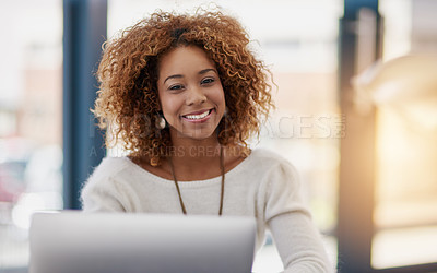 Buy stock photo Portrait of a young businesswoman sitting at her laptop in an office