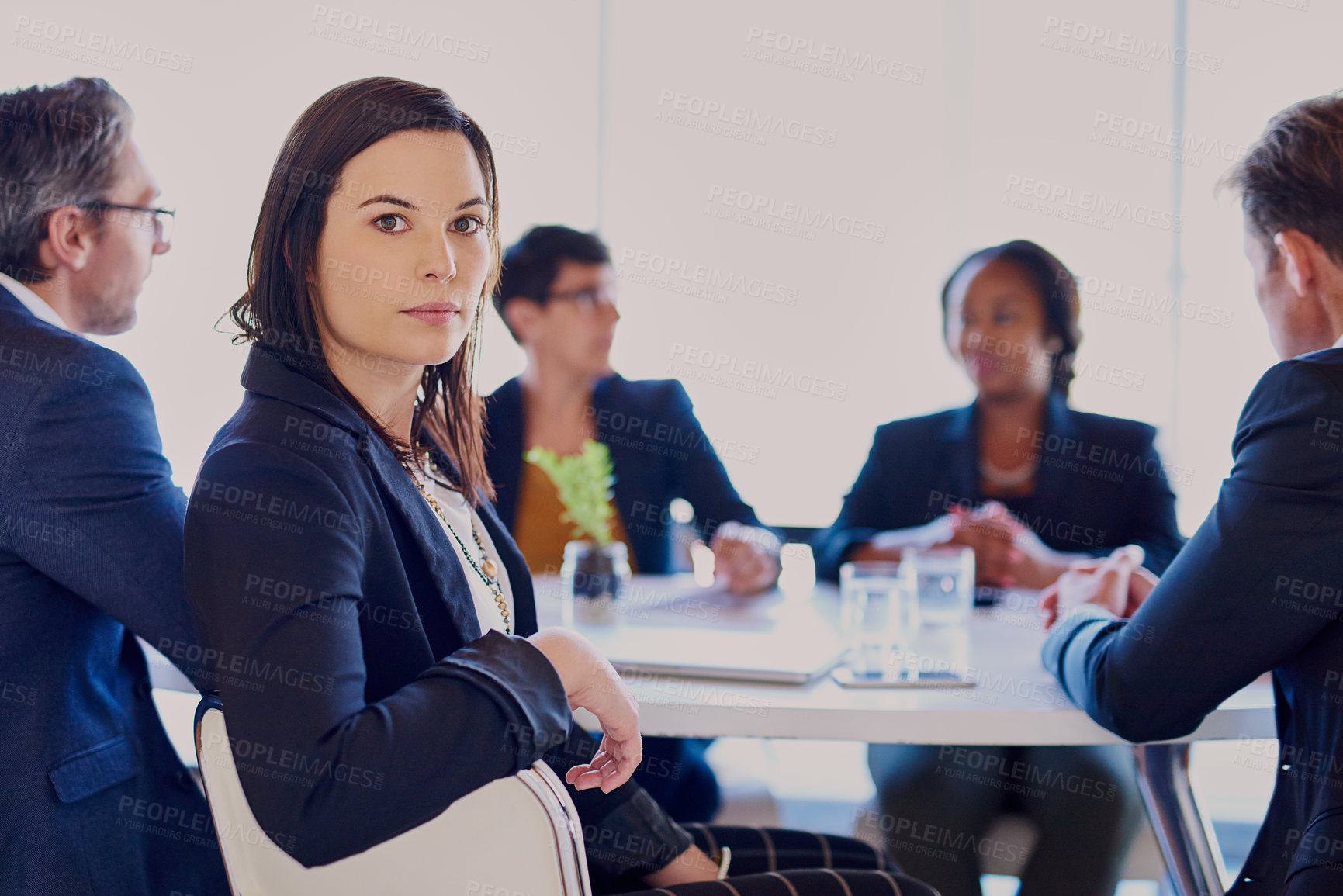 Buy stock photo Cropped portrait of a businesswoman sitting in the boardroom with her colleagues