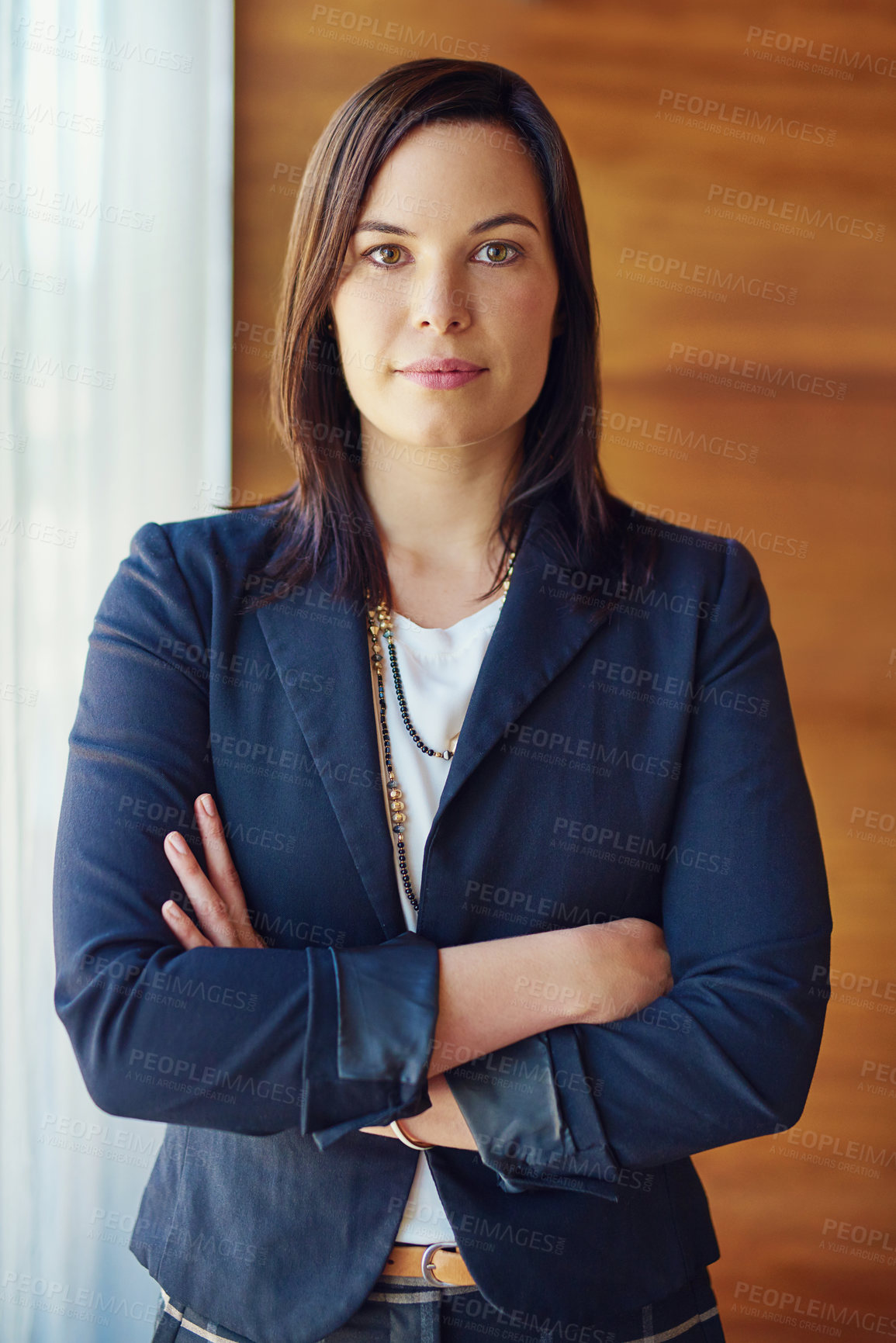 Buy stock photo Portrait of a confident businesswoman standing in her office