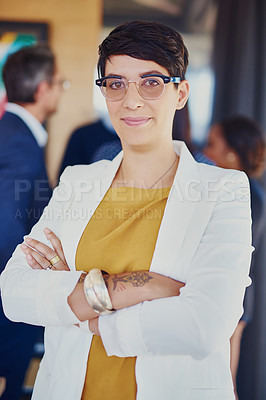 Buy stock photo Cropped portrait of a businesswoman standing in the office with her colleagues in the background